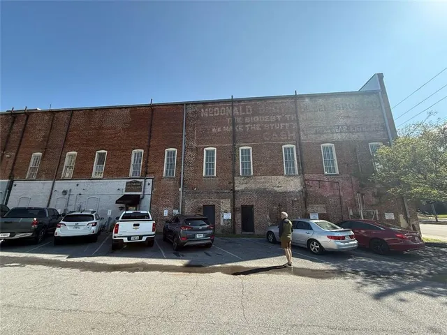 a couple of cars parked in front of a building