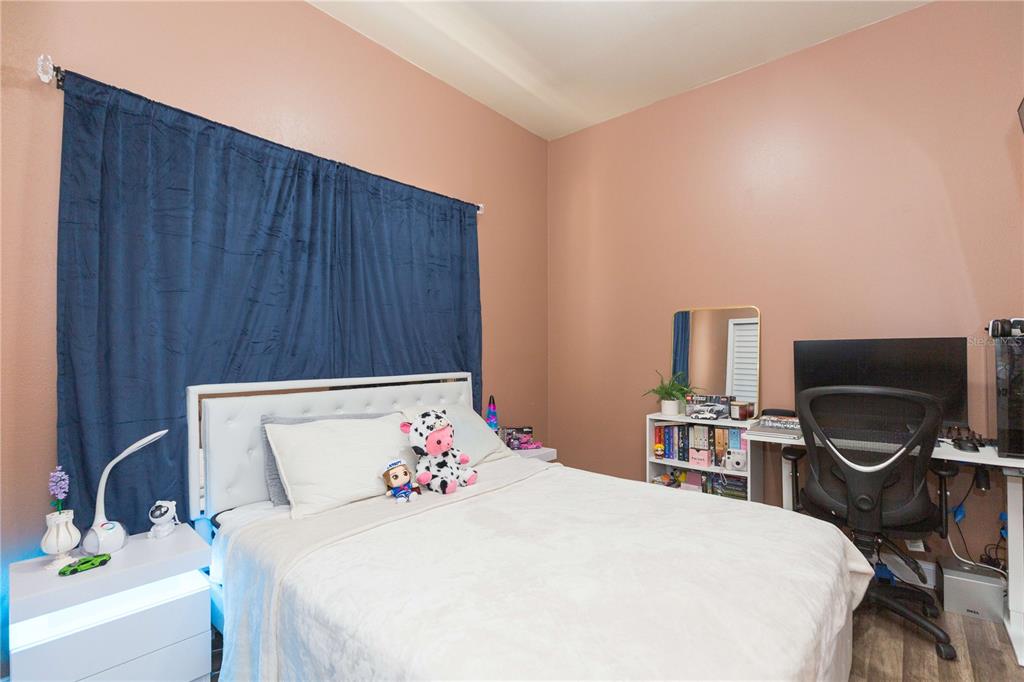 2322 West Cherry Street Tampa, FL 33607 - Photo 7 of 36 a bedroom with a bed and a flat screen tv