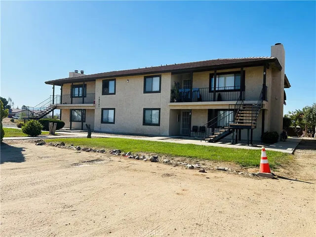 a view of a house with a yard and plants