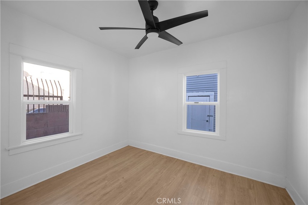 1364 Cherry Long Beach, CA 90813 - Photo 6 of 14 a view of an empty room with a window and wooden floor
