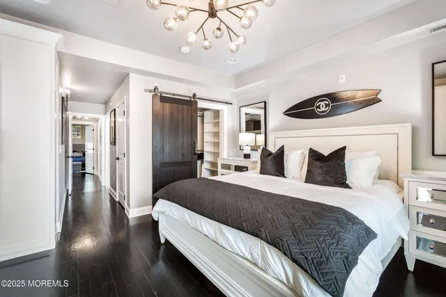 a bedroom with a bed and a mirror