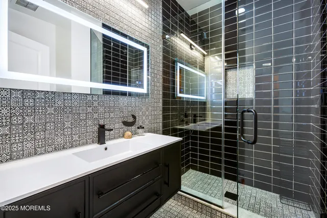 a bathroom with a sink toilet shower and window