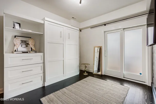 a bedroom with a bed and cabinet