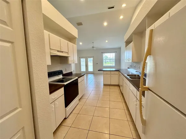 a kitchen with stainless steel appliances a refrigerator sink and cabinets