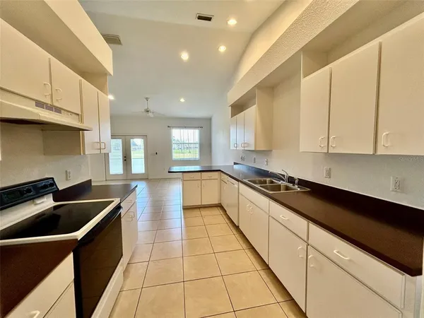 a kitchen with stainless steel appliances granite countertop a sink and cabinets