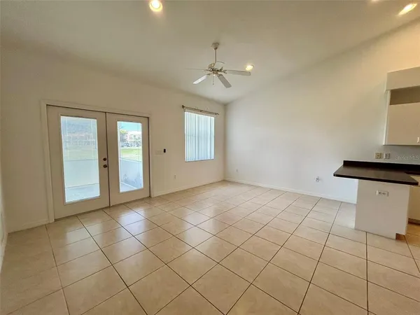 a view of an empty room with window and cabinet
