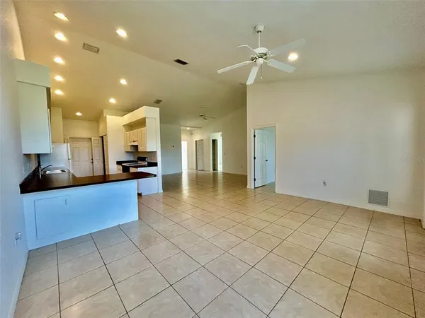 a large kitchen with a large counter top and stainless steel appliances