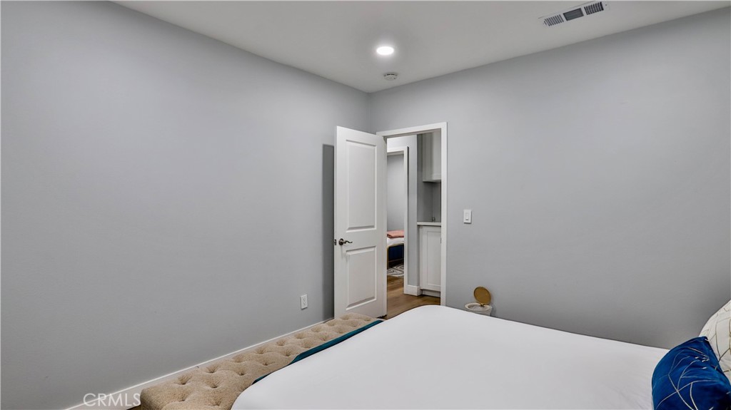408 South Flower Street Santa Ana, CA 92703 - Photo 21 of 71 a bedroom with a bed and a table