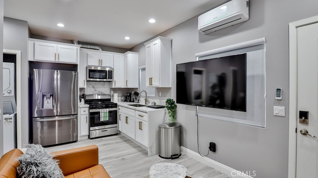 408 South Flower Street Santa Ana, CA 92703 - Photo 38 of 71 a kitchen with stainless steel appliances granite countertop a refrigerator a stove and a sink