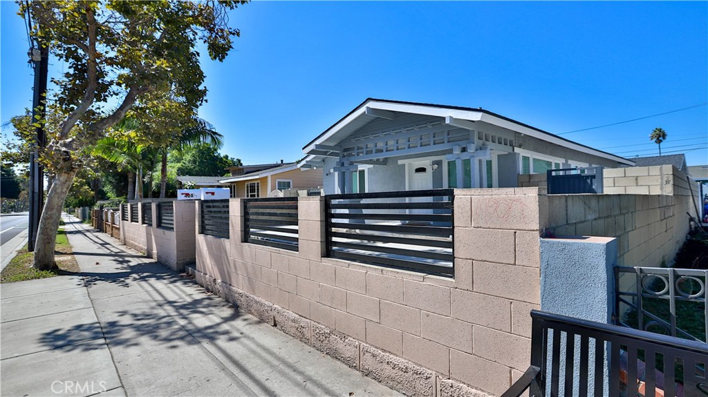 408 South Flower Street Santa Ana, CA 92703 - Photo 67 of 71 a front view of a house with wooden fence