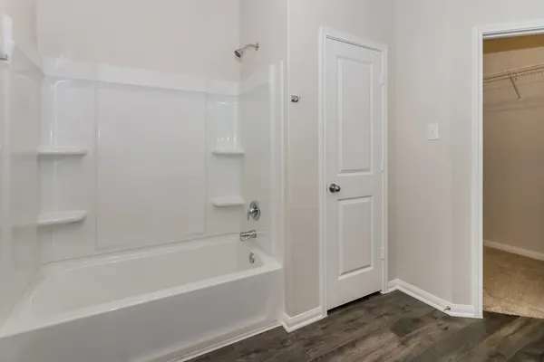 a view of a big room with windows and chandelier fan