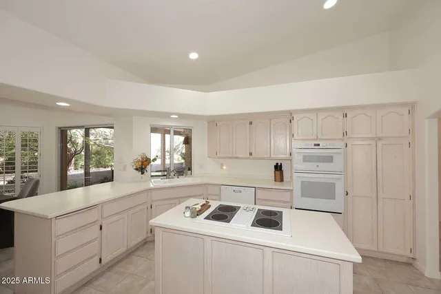 a bathroom with a sink a toilet and shower a mirror