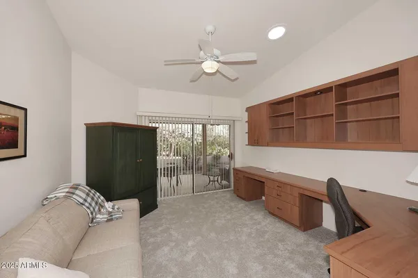 a bedroom with a bed a flat screen tv and a couch