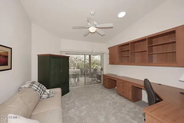 a bedroom with a bed a flat screen tv and a couch