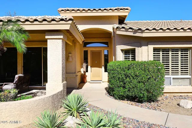 a living room with patio furniture and a floor to ceiling window