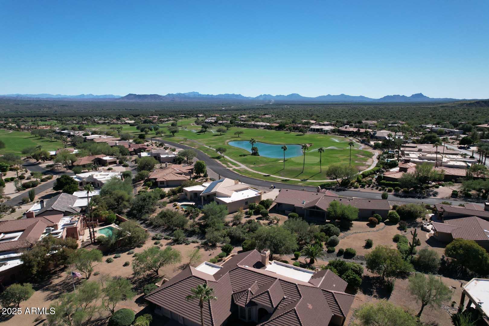 18510 East Leather Lane Rio Verde, AZ 85263 - Photo 54 of 67 an aerial view of a city with lots of residential buildings and mountain view in back