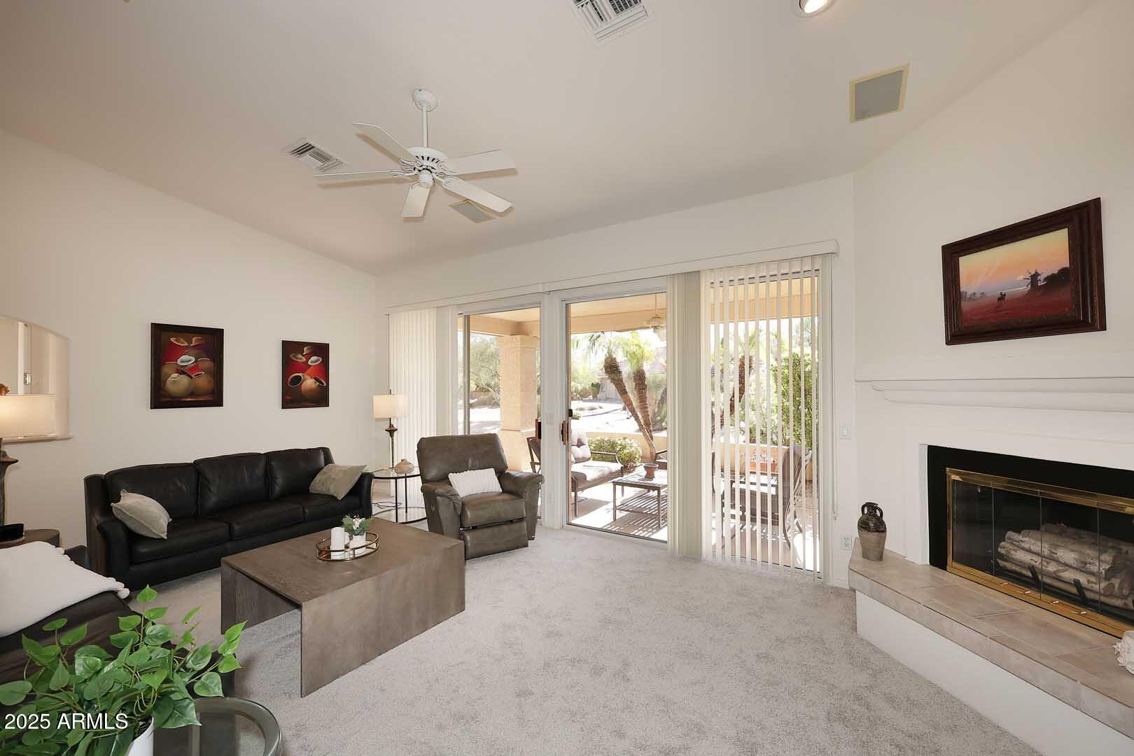 18510 East Leather Lane Rio Verde, AZ 85263 - Photo 10 of 67 a living room with furniture a fireplace and a flat screen tv