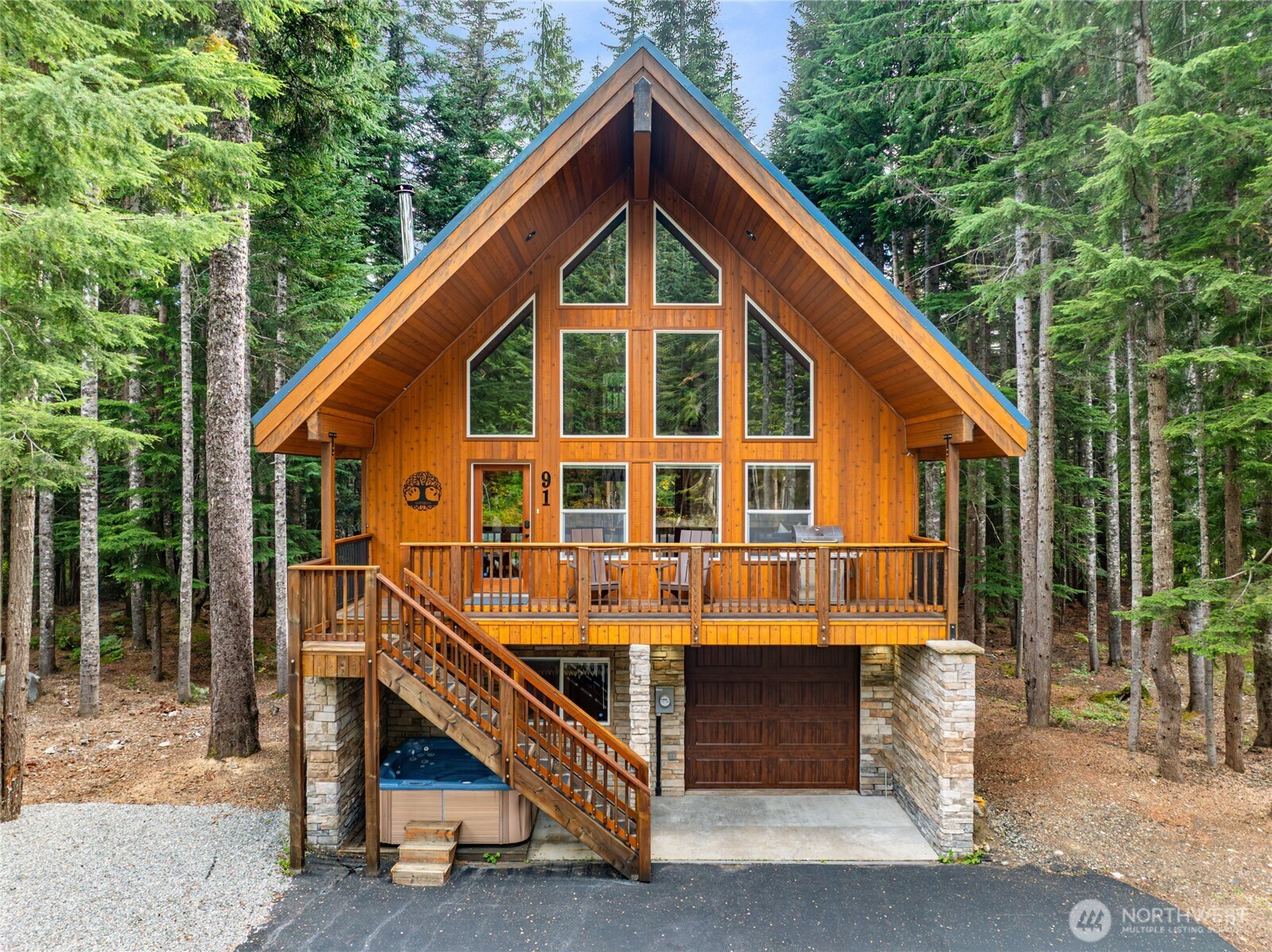 91 Mountain Home Road Snoqualmie Pass, WA 98068 - Photo 30 of 32 a view of a house with large windows and a small yard