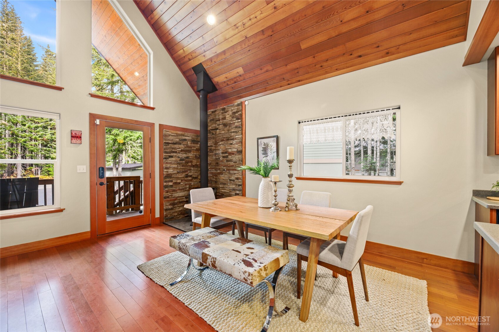 91 Mountain Home Road Snoqualmie Pass, WA 98068 - Photo 5 of 34 a view of a dining room with furniture large window and wooden floor