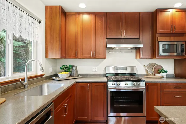 a kitchen that has a sink and a stove in it