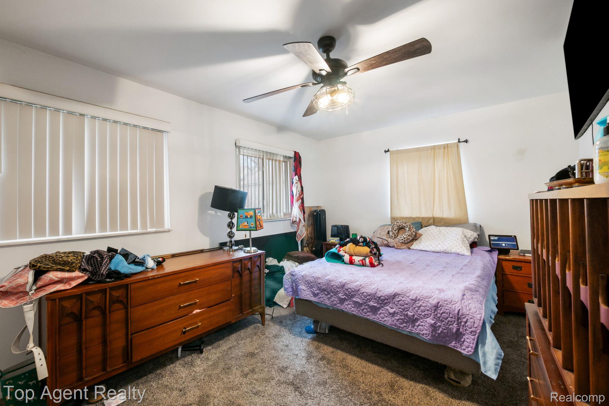 2065 Ridgemont Street Commerce Township, MI 48382 - Photo 20 of 35 Bedroom with ceiling fan and dark colored carpet