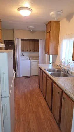 a kitchen with a sink stove and refrigerator