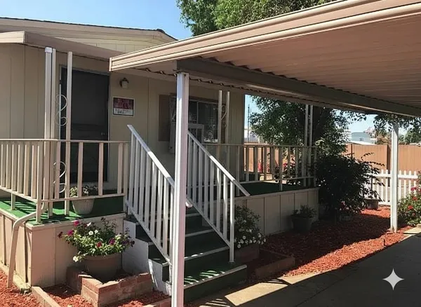 a view of a house with a porch and furniture