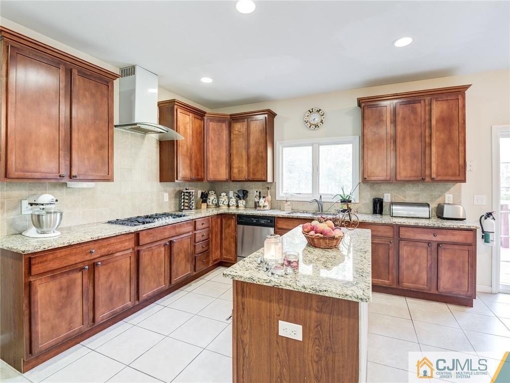110 Cottrell Road Old Bridge, NJ 07747 - Photo 11 of 25 a kitchen with stainless steel appliances granite countertop wooden cabinets a sink and dishwasher