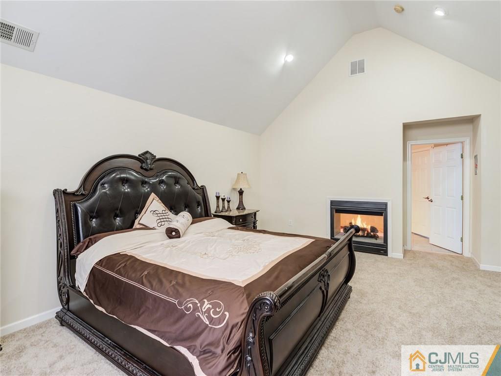 110 Cottrell Road Old Bridge, NJ 07747 - Photo 16 of 25 a bedroom with a bed and a stove