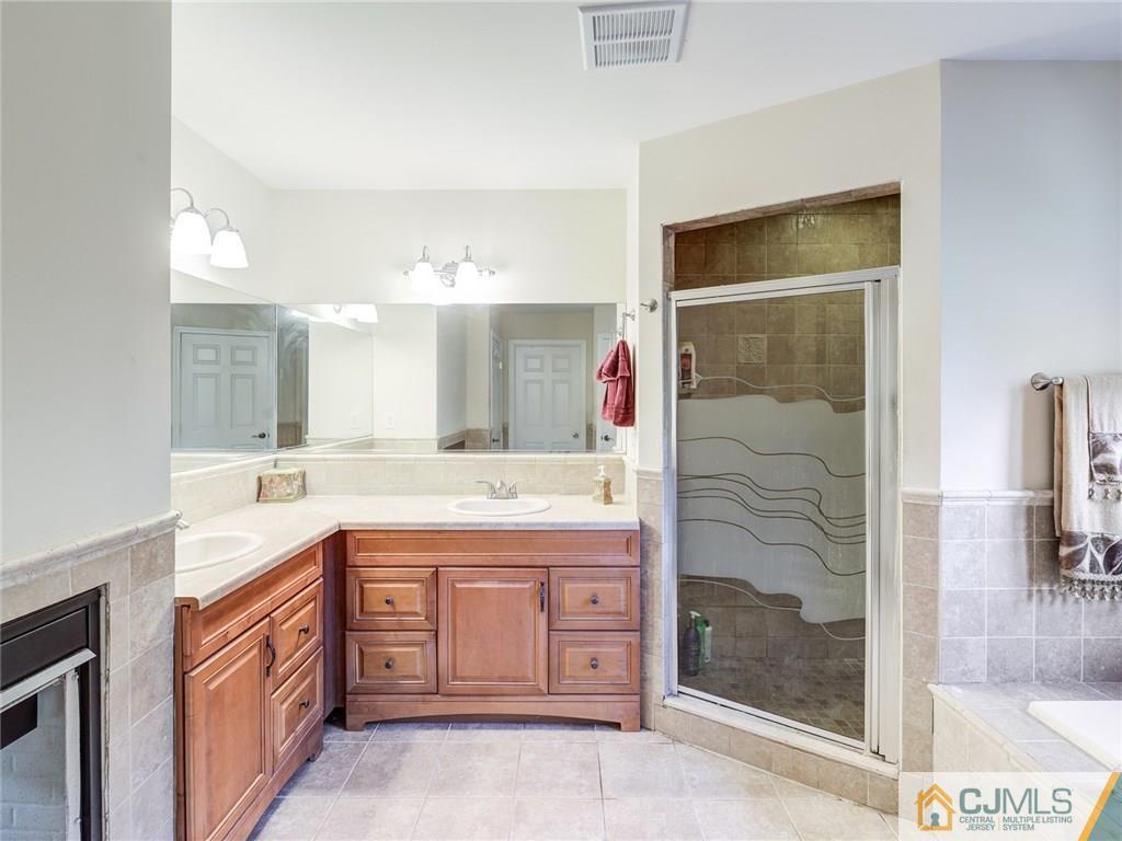 110 Cottrell Road Old Bridge, NJ 07747 - Photo 17 of 25 a spacious bathroom with a granite countertop sink a mirror and a shower