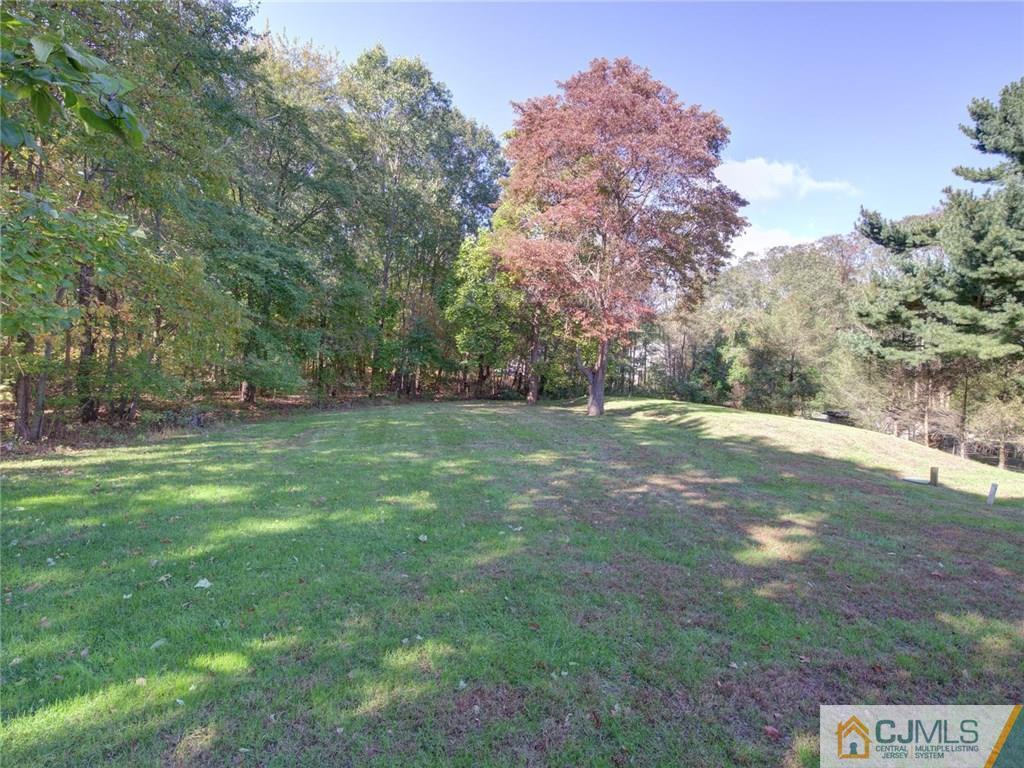 110 Cottrell Road Old Bridge, NJ 07747 - Photo 24 of 25 a view of outdoor space with green field and trees all around