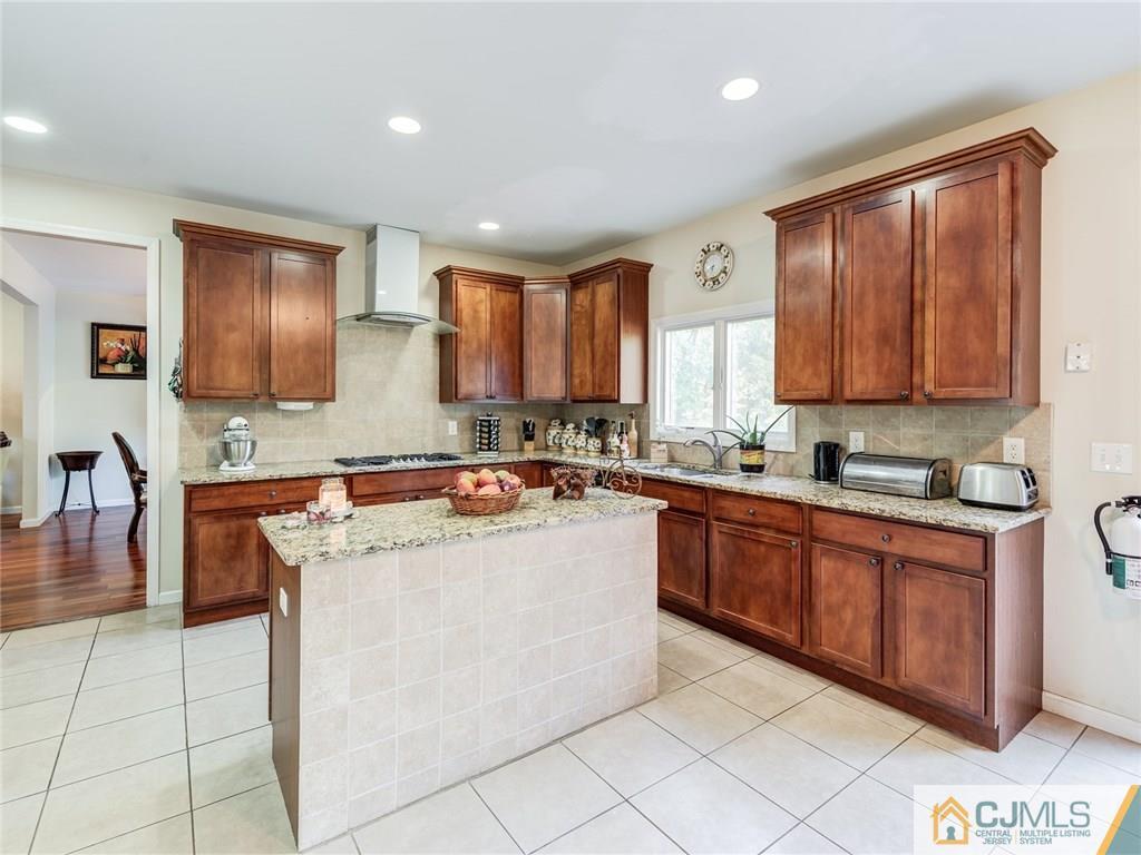 110 Cottrell Road Old Bridge, NJ 07747 - Photo 10 of 25 a kitchen with stainless steel appliances granite countertop a stove top oven a sink a counter top space and cabinets