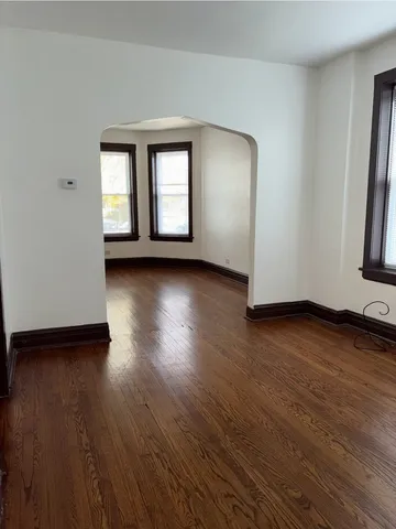 a white toilet sitting next to a bath tub and a shower