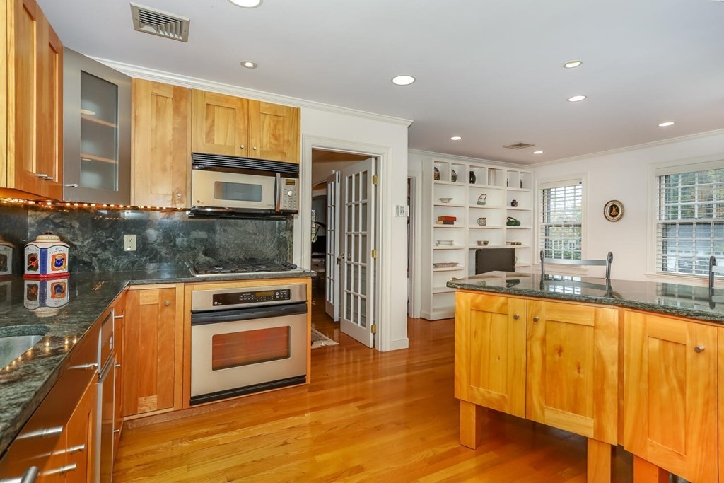 160 High Street Canton, MA 02021 - Photo 4 of 22 a kitchen with stainless steel appliances granite countertop a refrigerator and a stove top oven
