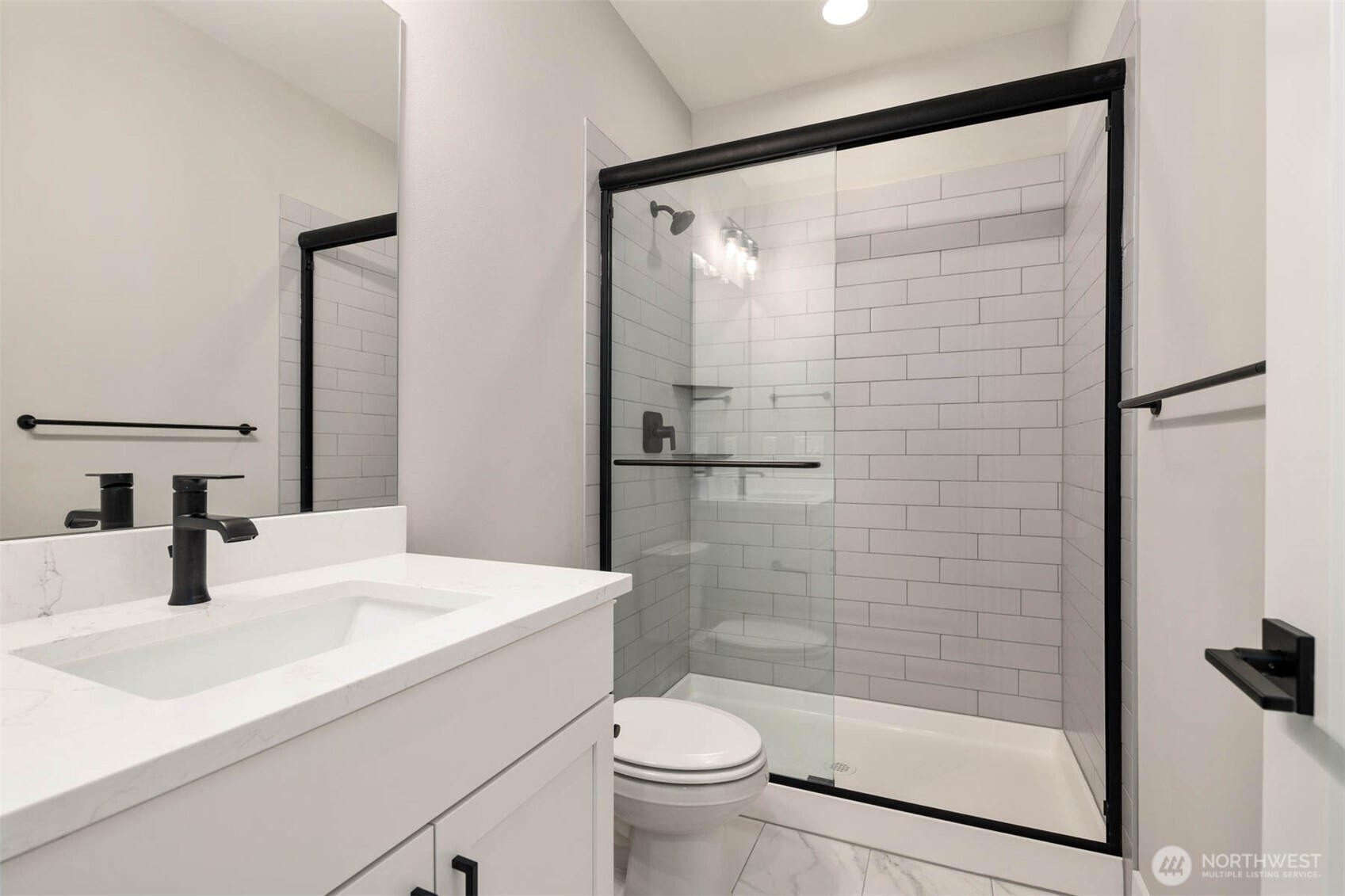 7560 South 130th Place Seattle, WA 98178 - Photo 17 of 27 a bathroom with a sink a toilet and shower