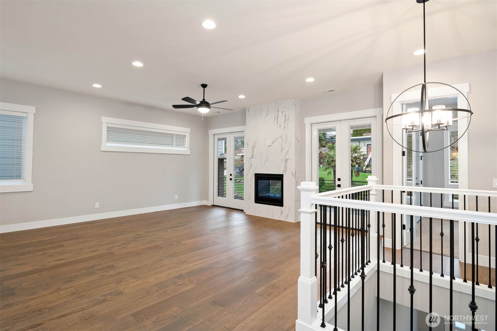 7560 South 130th Place Seattle, WA 98178 - Photo 21 of 27 a view of empty room with wooden floor and fireplace