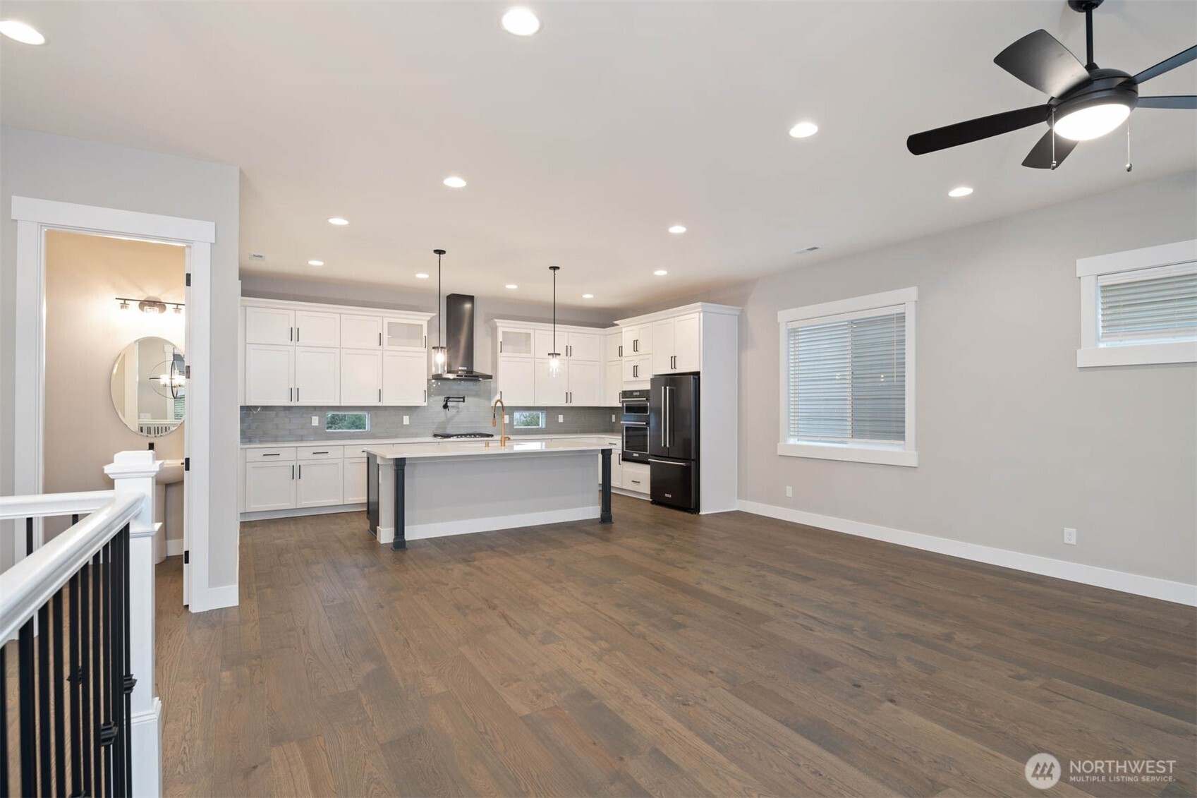 7560 South 130th Place Seattle, WA 98178 - Photo 22 of 27 a large kitchen with stainless steel appliances kitchen island granite countertop a large cabinets a sink and a stove