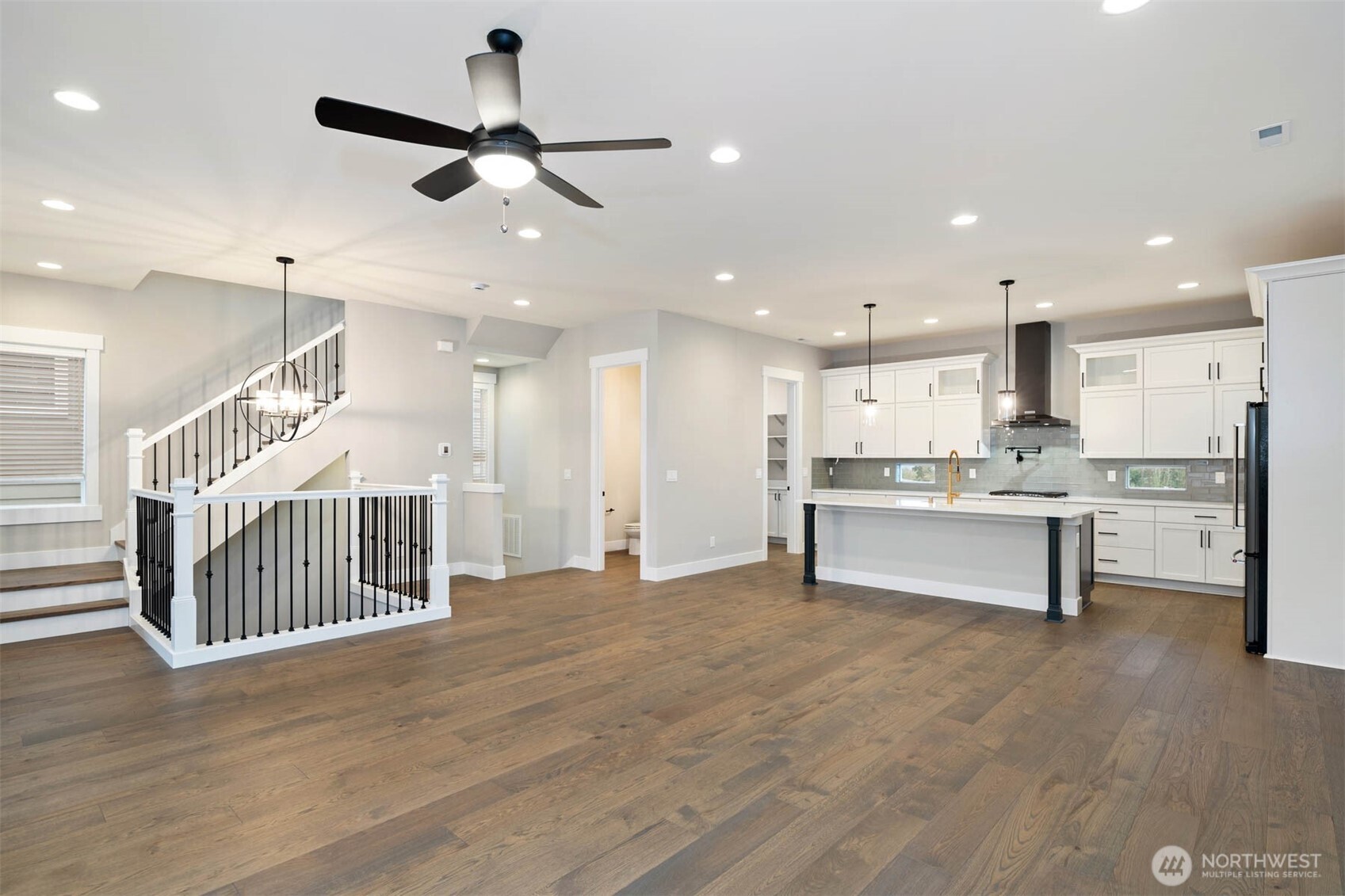 7560 South 130th Place Seattle, WA 98178 - Photo 23 of 27 a view of kitchen with kitchen island stainless steel appliances counter space and wooden floor