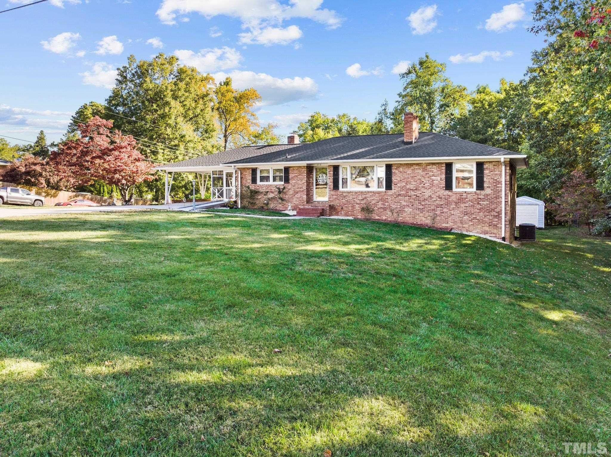 450 Younger Road Roxboro, NC 27573 - Photo 2 of 43 a view of a yard in front of a house with a large tree