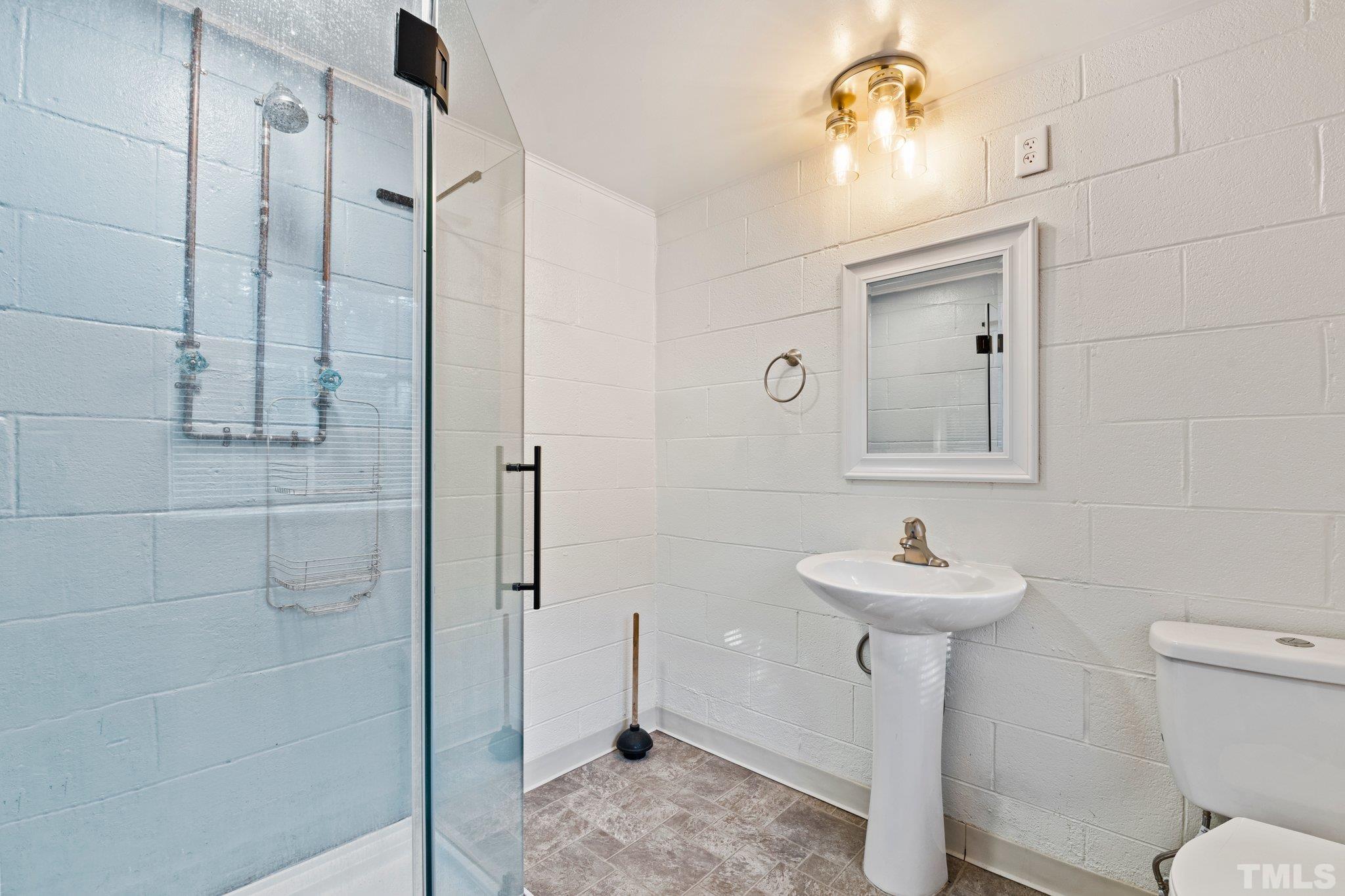 450 Younger Road Roxboro, NC 27573 - Photo 28 of 43 a bathroom with a sink a toilet and shower