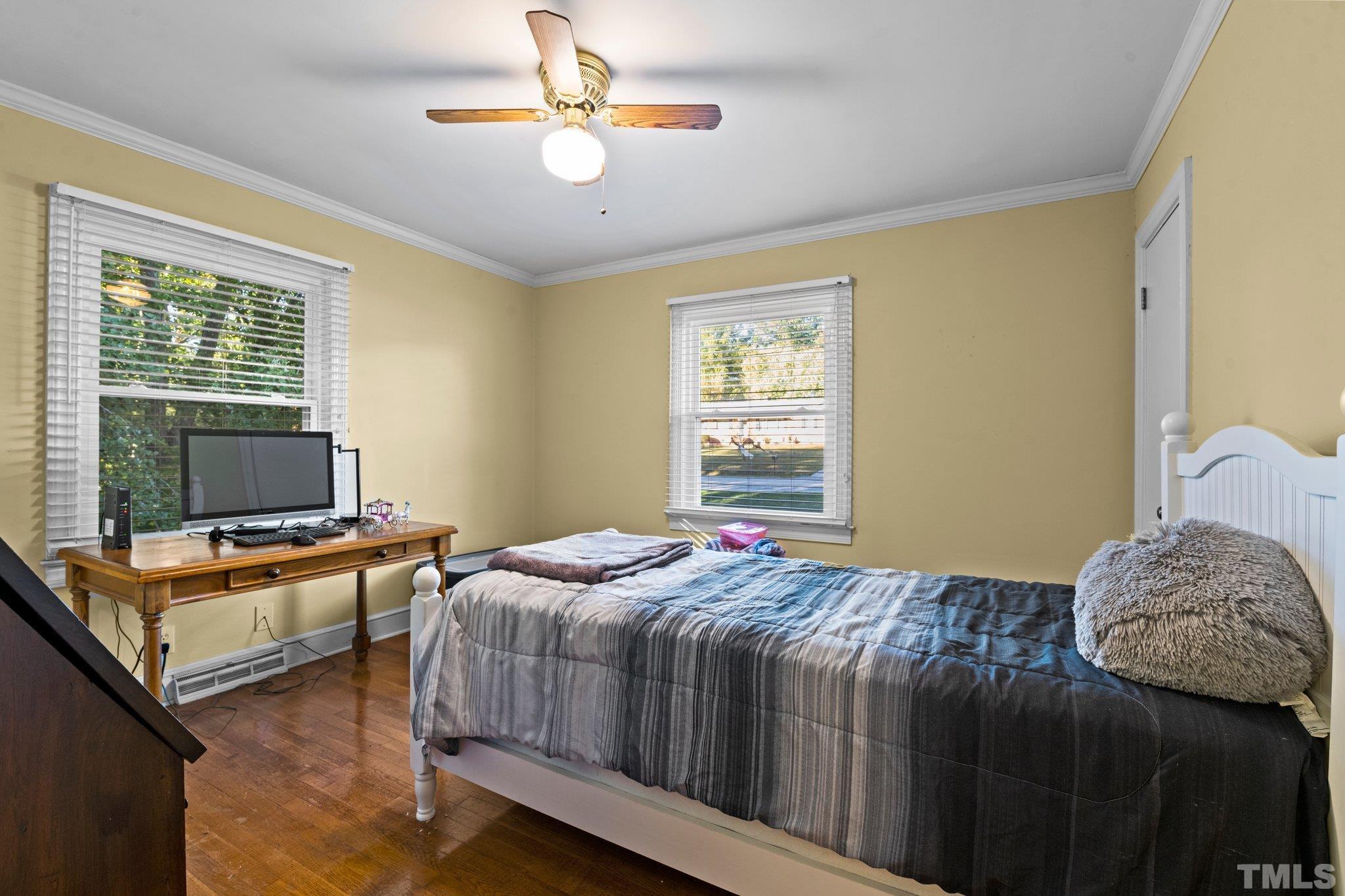 450 Younger Road Roxboro, NC 27573 - Photo 32 of 43 a bedroom with a bed and a chandelier