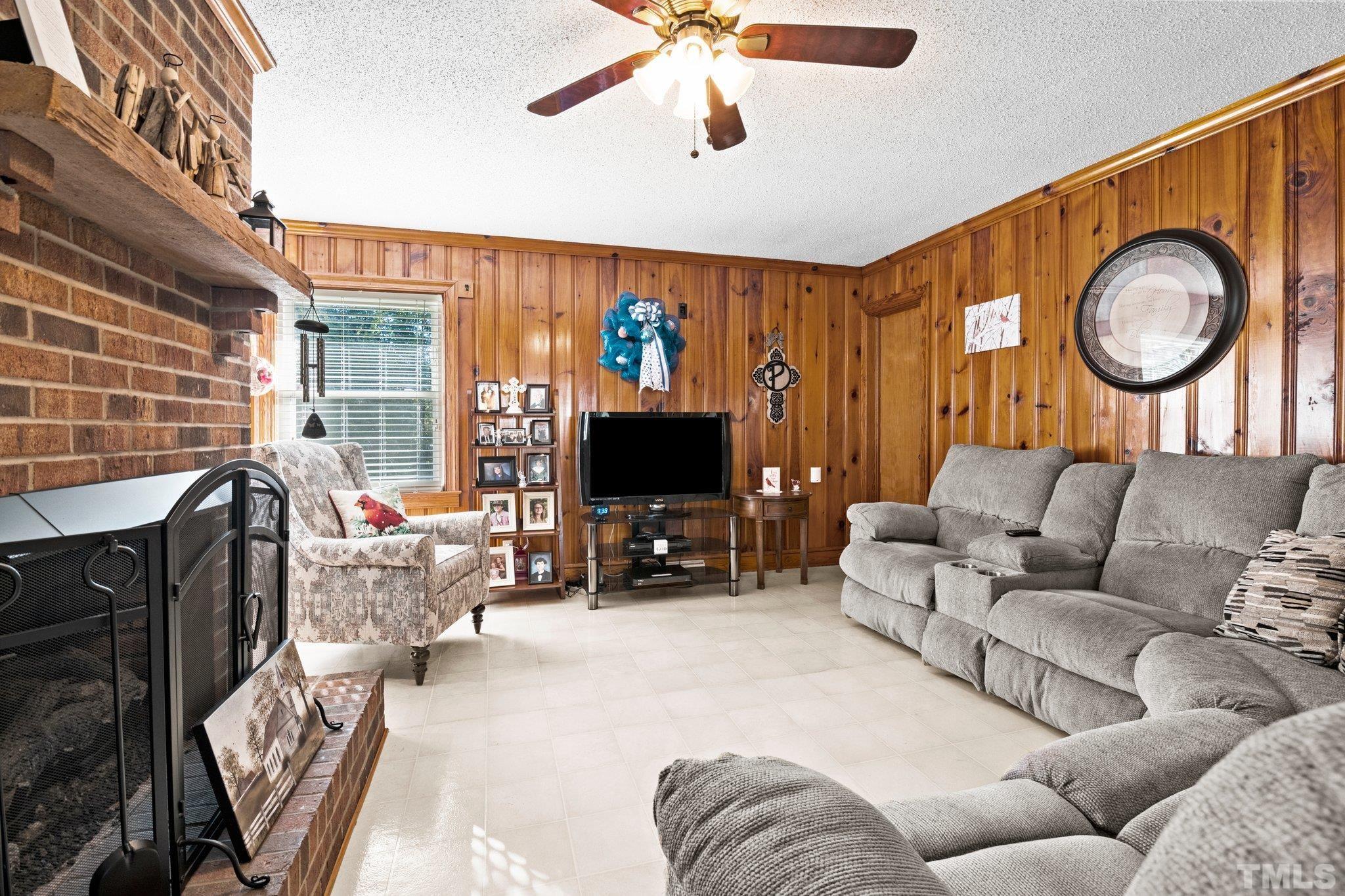450 Younger Road Roxboro, NC 27573 - Photo 41 of 43 a living room with furniture a fireplace and a flat screen tv