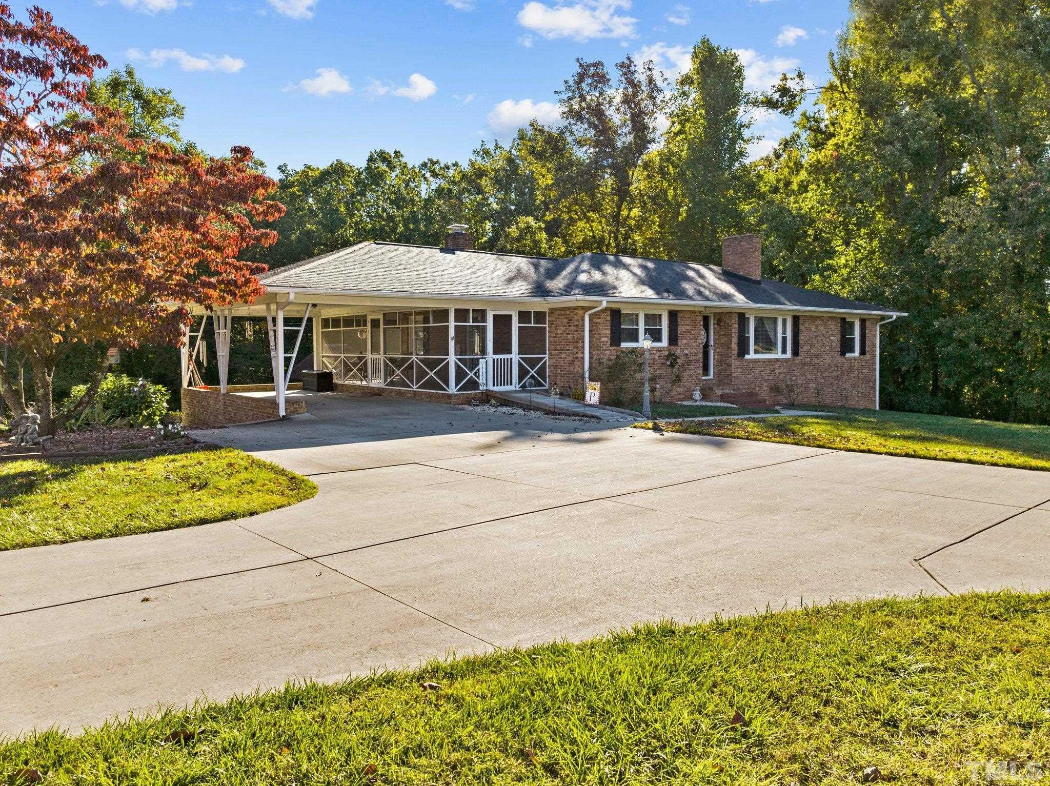 450 Younger Road Roxboro, NC 27573 - Photo 5 of 43 a front view of a house with a yard and trees