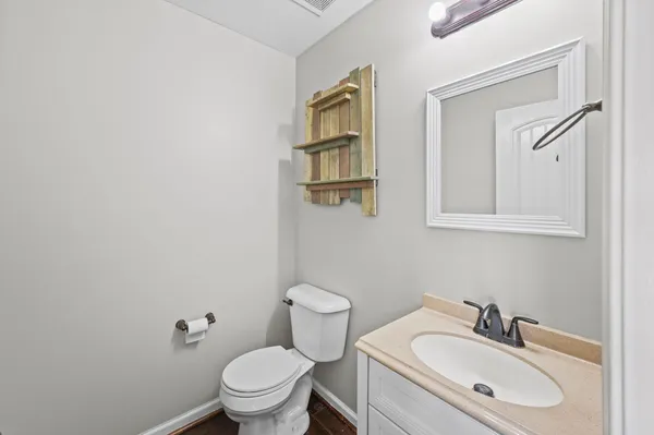 a bathroom with a sink toilet and a mirror
