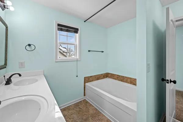 a bathroom with a tub and sink