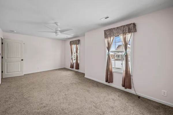 an empty room with windows and closet