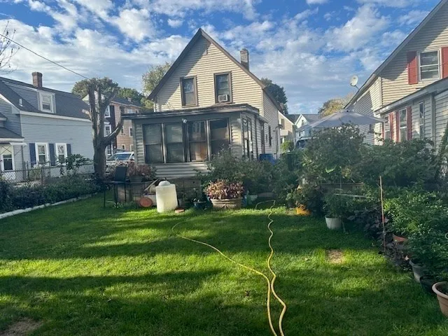 a front view of a house with a yard and trees