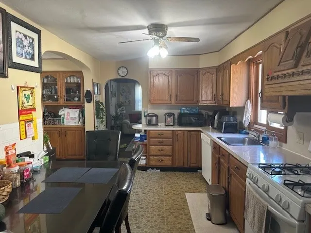 a kitchen with stainless steel appliances granite countertop a stove refrigerator and cabinets
