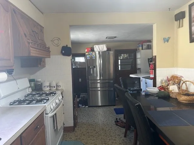 a kitchen with refrigerator and stove