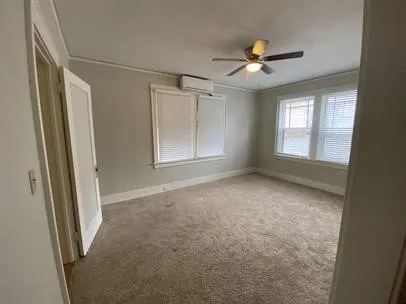 a view of a big room with closet and a ceiling fan